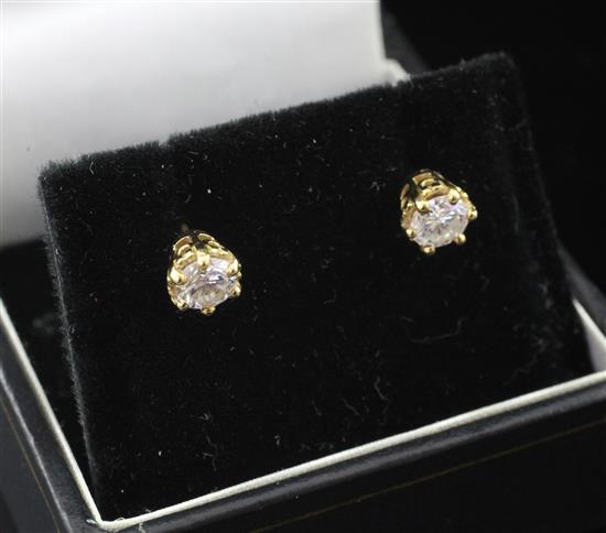 A pair of gold and solitaire diamond ear studs,